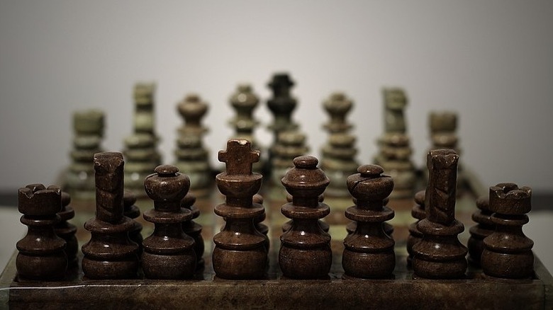 A row of squat wooden chess pieces