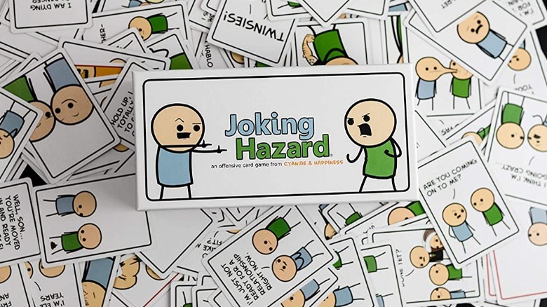 A scattered pile of Joking Hazard cards, each showing a blue stick figure and a green stick figure