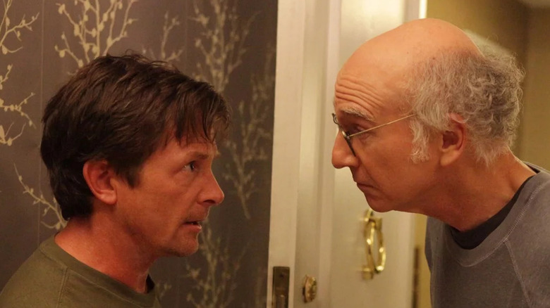 Larry David looks at Michael J. Fox