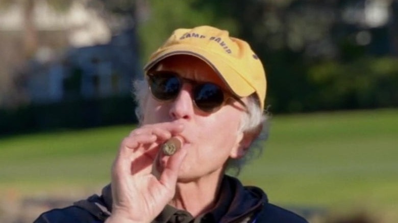 Larry David smokes cigar