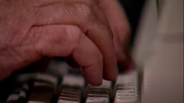 Hands type on a keyboard