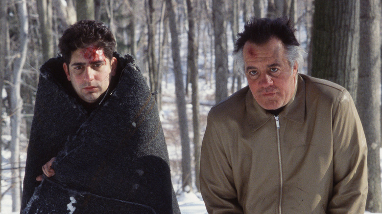 Christopher and Paulie stand in snowy woods