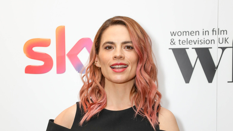 Atwell on red carpet with pink hair 