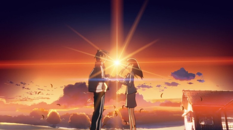 Hiroki and Sayuri holding hands at sunset