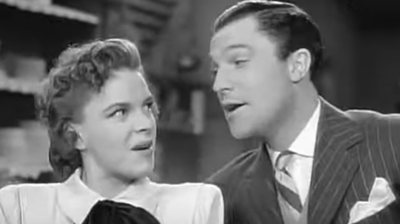 Judy Garland glances at Gene Kelly