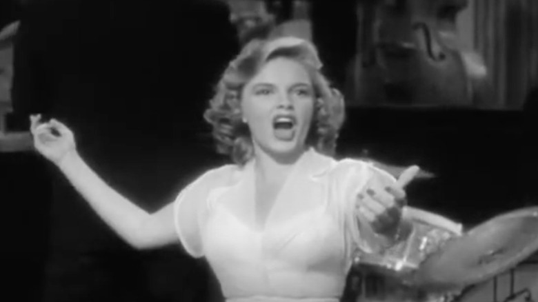 Judy Garland makes hand gestures 