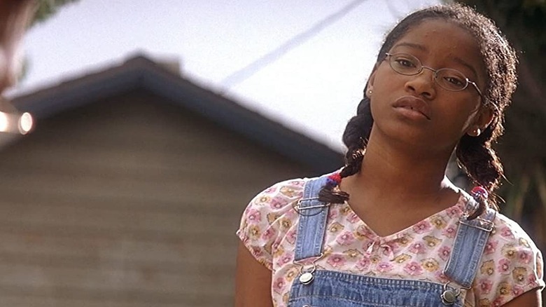 Akeelah in glasses and overalls 