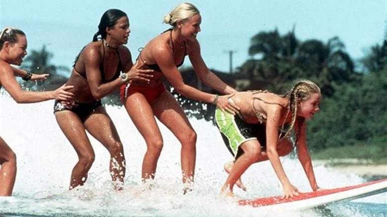 The four girls on a surfboard 