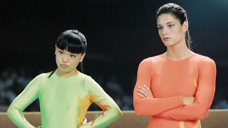 Nikki SooHoo and Missy Peregrym standing in leotards