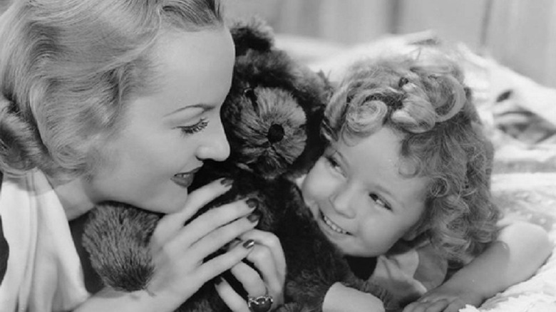 Shirley Temple hugs a teddy bear