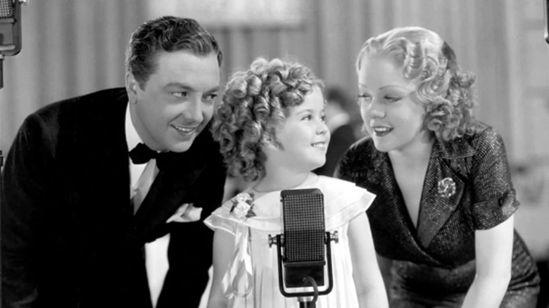 Shirley Temple sings at a microphone