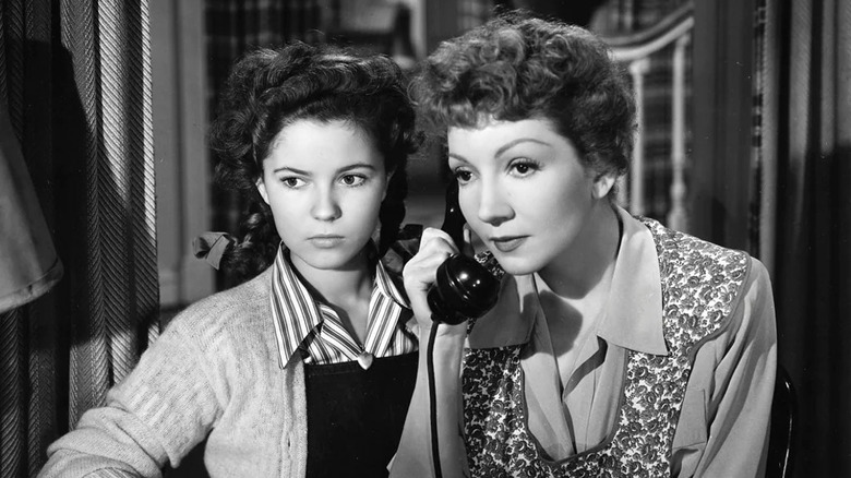 Shirley Temple listens to a phone call