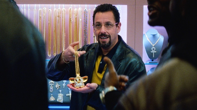 Adam Sandler holding jewelry