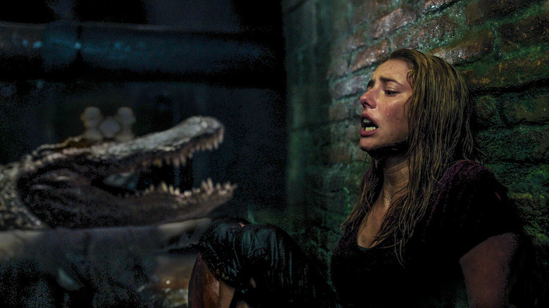 Haley Keller next to alligator in sewer