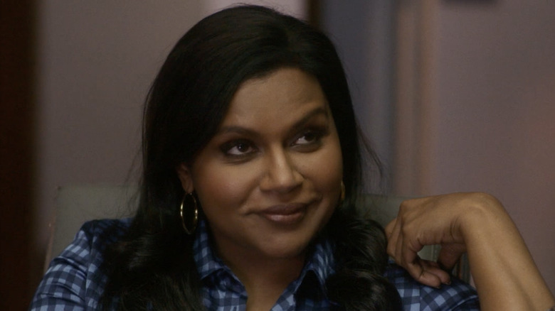 Mindy Kaling smirks