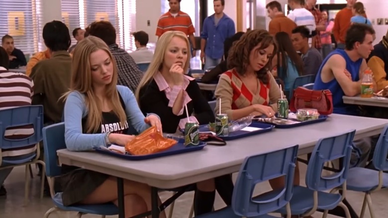 The Plastics sit at table