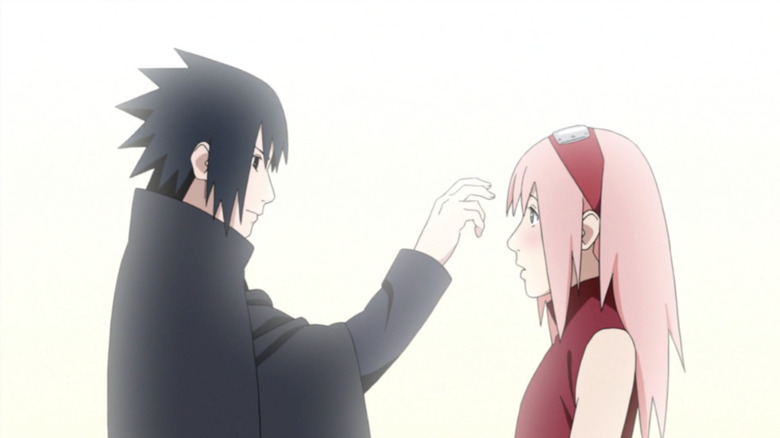 Sasuke pokes Sakura's forehead