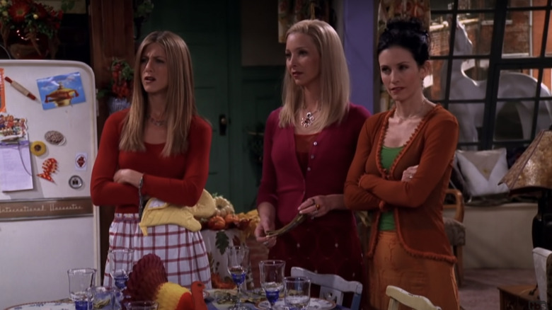 Rachel, Phoebe, and Monica standing