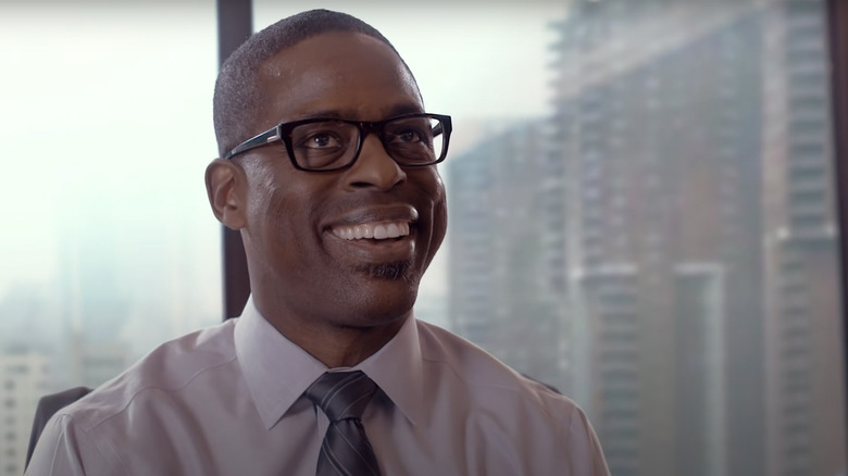 Randall Pearson smiling near window