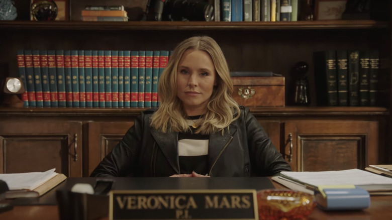 Veronica Mars sitting behind desk