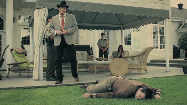 Michael Madsen stands over a corpse Real Detective