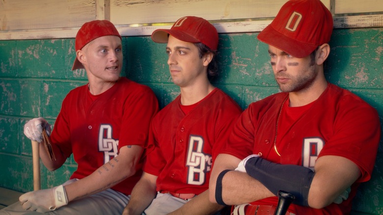 three players in the dugout