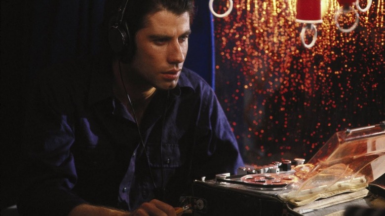 Travolta listens to a recording