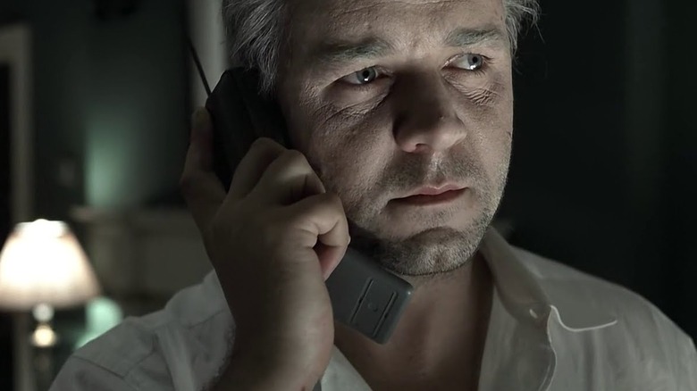 Russell Crowe holds a phone