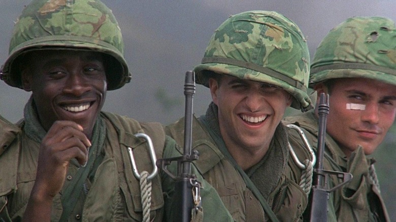 Three soldiers smile