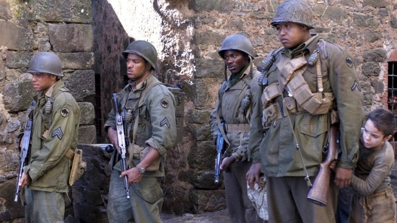 A group of soldiers and a little boy