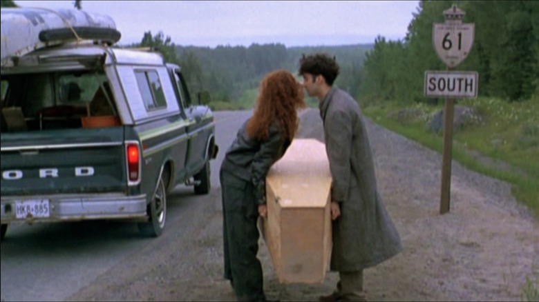 Valerie Buhagiar and Don McKellar kissing over a coffin