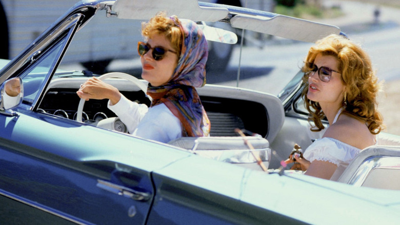 Susan Sarandon and Geena Davis driving an open-top car