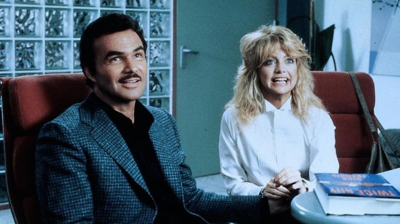 Goldie Hawn sits at desk