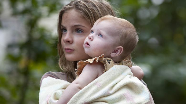 Lizzie Samuels holding Judith Grimes on The Walking Dead