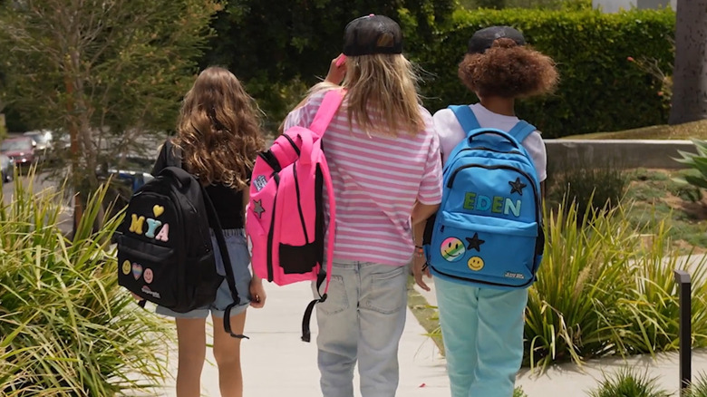 Three kids walking with customized backpacks