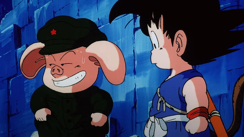 Oolong grins as Goku looks on