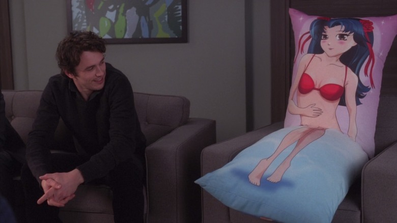 James Franco looks at a body pillow