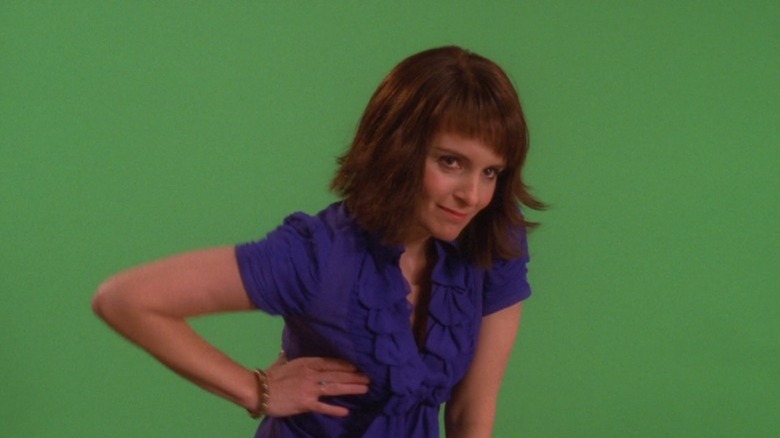 Liz Lemon poses in front of green screen