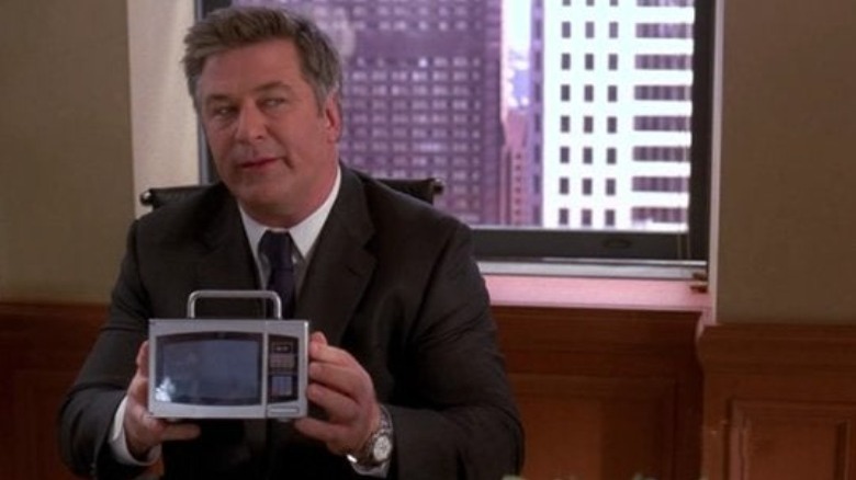 Jack Donaghy holds a small microwave