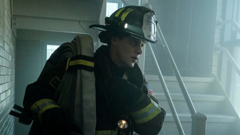 A firefighter climbs stairs Chicago Fire