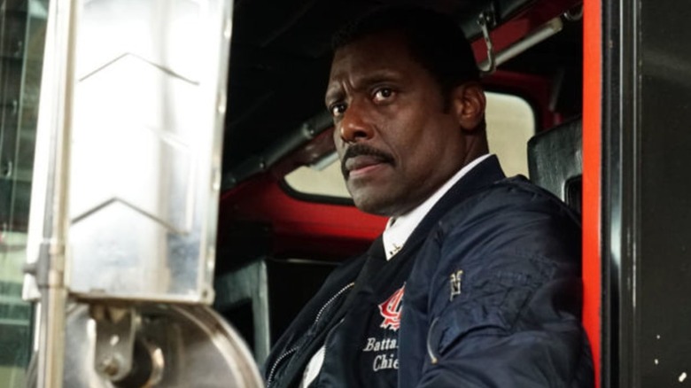 A firefighter looks up Chicago Fire