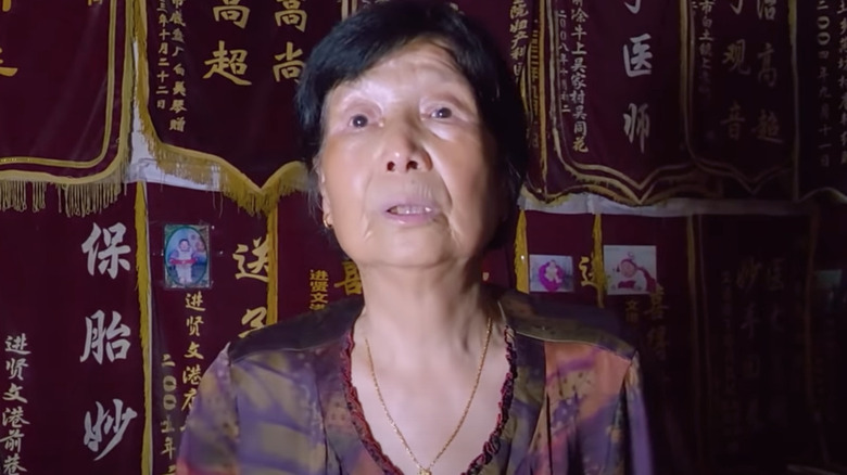 Chinese woman against red banners