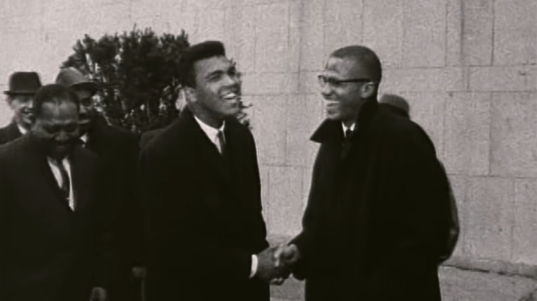 Malcolm X and Muhammad Ali shaking hands