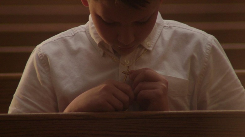 Boy prays in church