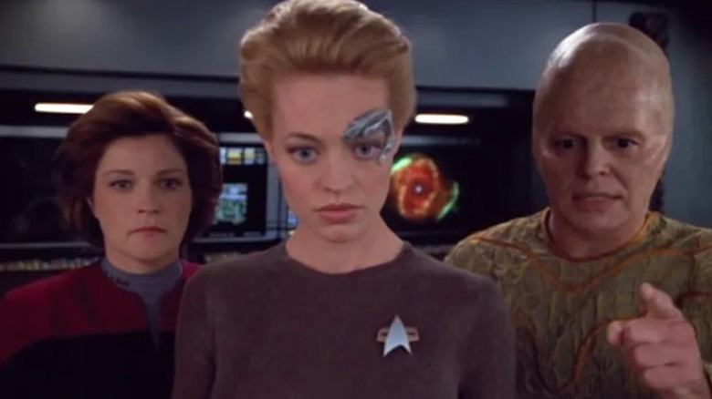 Seven, Janeway, and Arturis look at a moniter