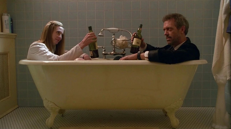 House and Amber sit in a bathtub