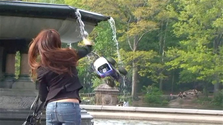 Woman throwing car into fountain