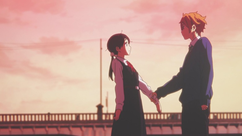 Mochizō holding Tamako's hand outside