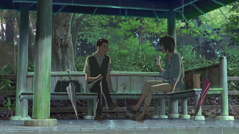 Takao and Yukari talking in a gazebo