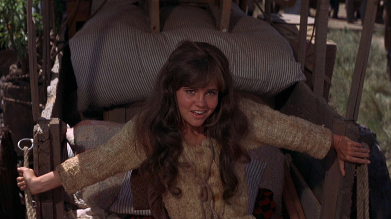 Sally Field sits in wagon